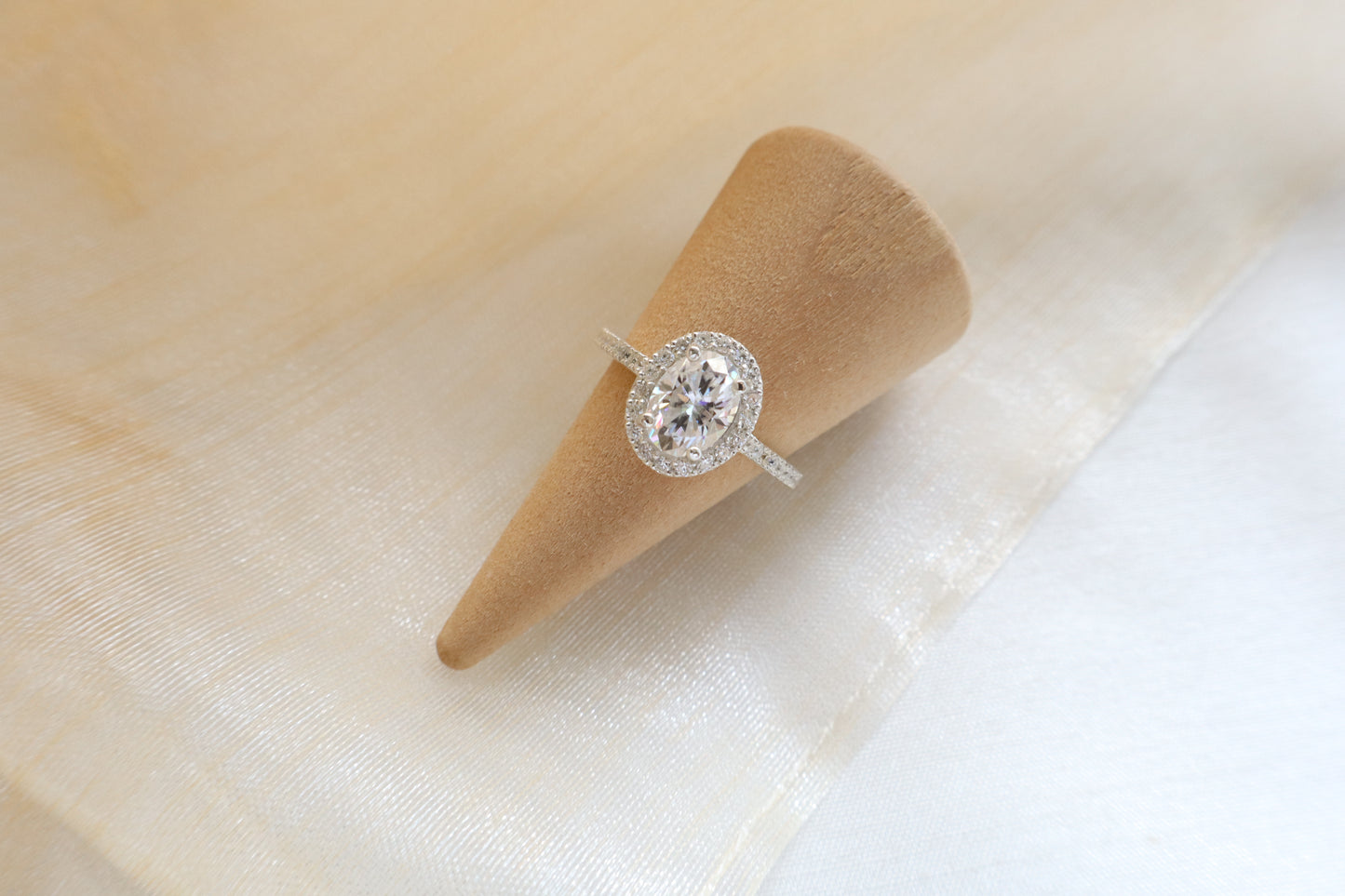 Custom gold bridal ring set with a moissanite engagement ring, diamond wedding band, and engraved groom’s ring, designed as a cohesive family heirloom. Eco-friendly abaca packaging. Singapore corporate jewelry.