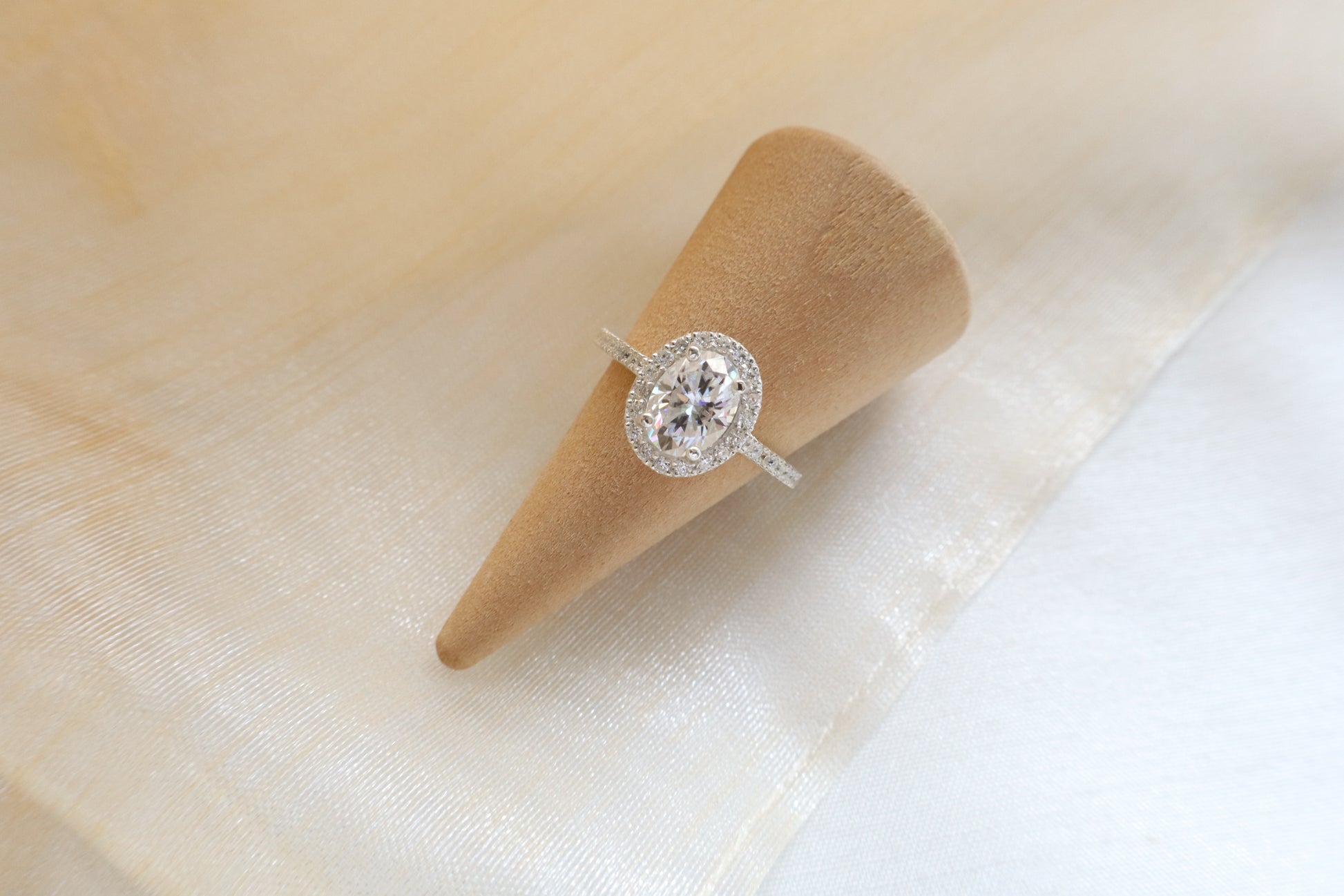 Custom gold bridal ring set with a moissanite engagement ring, diamond wedding band, and engraved groom’s ring, designed as a cohesive family heirloom. Eco-friendly abaca packaging. Singapore corporate jewelry.