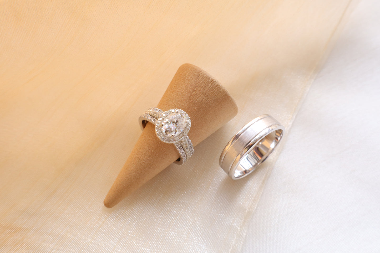 Custom gold bridal ring set with a moissanite engagement ring, diamond wedding band, and engraved groom’s ring, designed as a cohesive family heirloom. Eco-friendly abaca packaging. Singapore corporate jewelry.