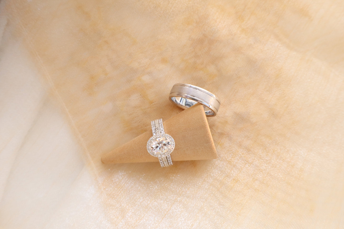 Custom gold bridal ring set with a moissanite engagement ring, diamond wedding band, and engraved groom’s ring, designed as a cohesive family heirloom. Eco-friendly abaca packaging. Singapore corporate jewelry.