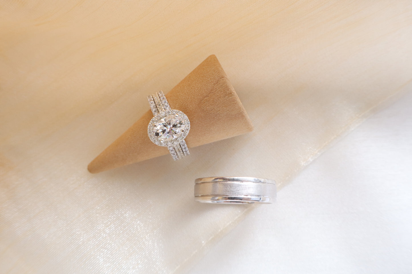Custom gold bridal ring set with a moissanite engagement ring, diamond wedding band, and engraved groom’s ring, designed as a cohesive family heirloom. Eco-friendly abaca packaging. Singapore corporate jewelry.