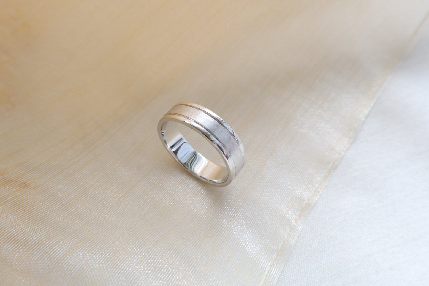 Custom gold bridal ring set with a moissanite engagement ring, diamond wedding band, and engraved groom’s ring, designed as a cohesive family heirloom. Eco-friendly abaca packaging. Singapore corporate jewelry.