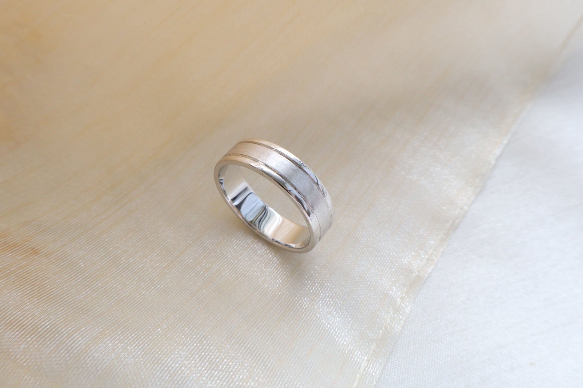 Custom gold bridal ring set with a moissanite engagement ring, diamond wedding band, and engraved groom’s ring, designed as a cohesive family heirloom. Eco-friendly abaca packaging. Singapore corporate jewelry.