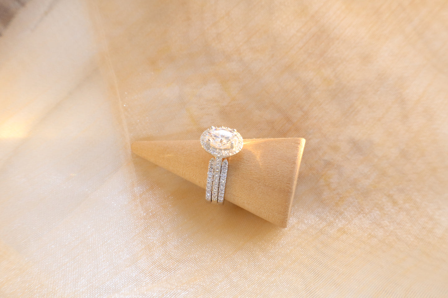 Custom gold bridal ring set with a moissanite engagement ring, diamond wedding band, and engraved groom’s ring, designed as a cohesive family heirloom. Eco-friendly abaca packaging. Singapore corporate jewelry.
