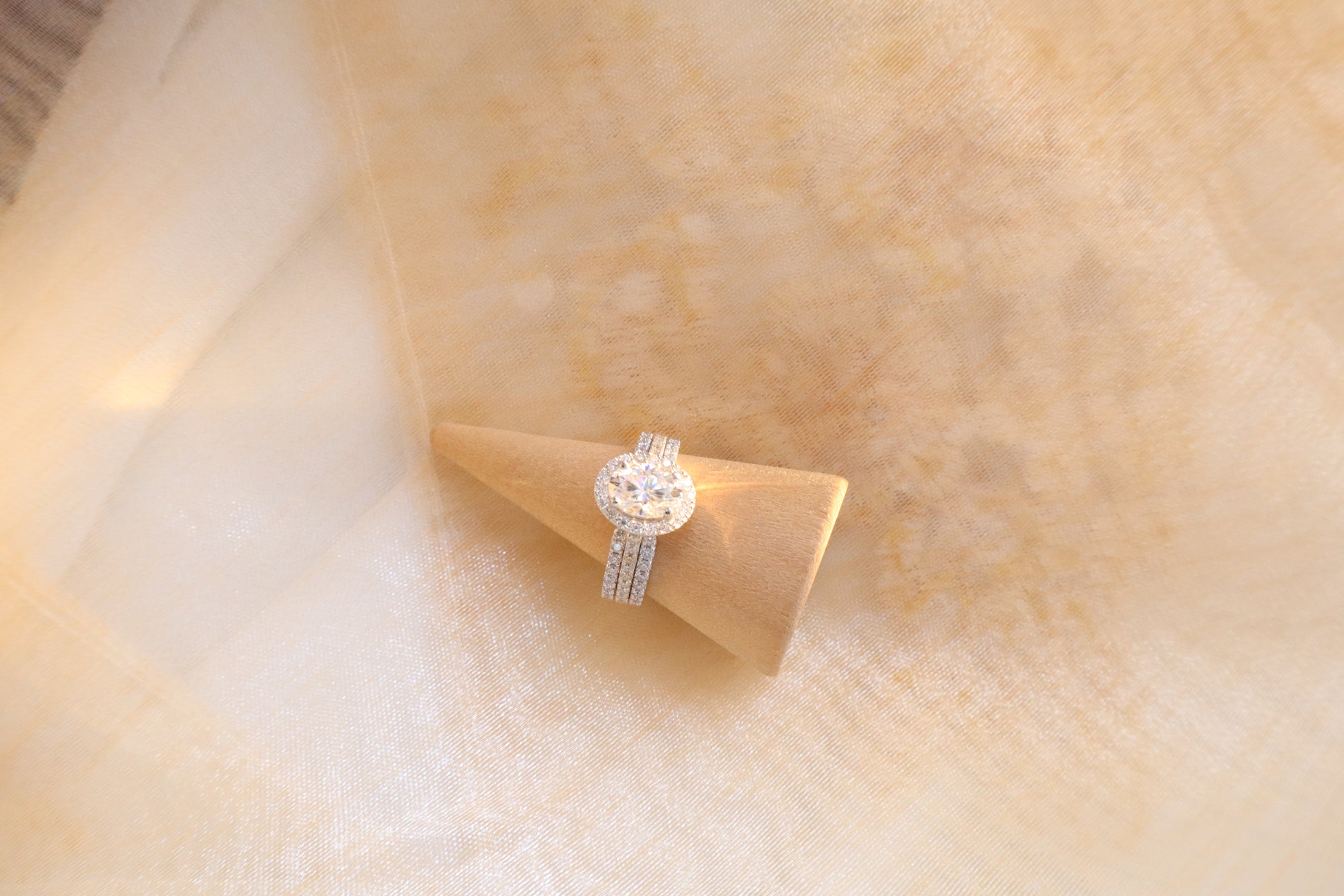 Custom gold bridal ring set with a moissanite engagement ring, diamond wedding band, and engraved groom’s ring, designed as a cohesive family heirloom. Eco-friendly abaca packaging. Singapore corporate jewelry.