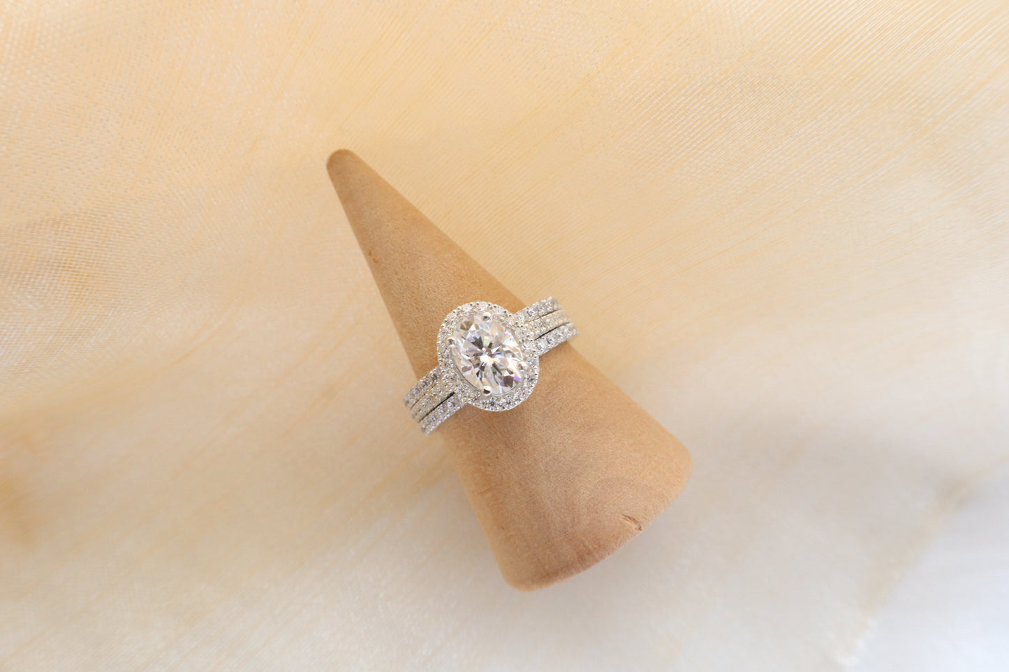 Custom gold bridal ring set with a moissanite engagement ring, diamond wedding band, and engraved groom’s ring, designed as a cohesive family heirloom. Eco-friendly abaca packaging. Singapore corporate jewelry.