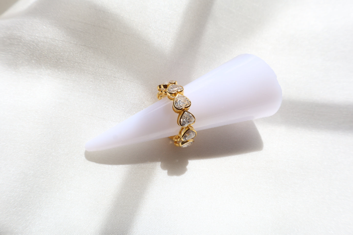 Custom 14K yellow gold ring with heart-cut diamonds, crafted using client-owned stones and secure precision setting, eco-friendly bespoke jewelry craftsmanship for Singapore clients.