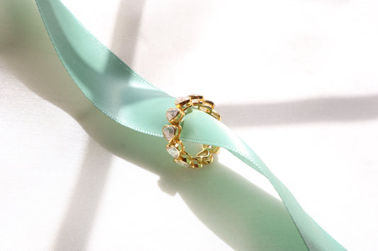 Custom 14K yellow gold ring with heart-cut diamonds, crafted using client-owned stones and secure precision setting, eco-friendly bespoke jewelry craftsmanship for Singapore clients.