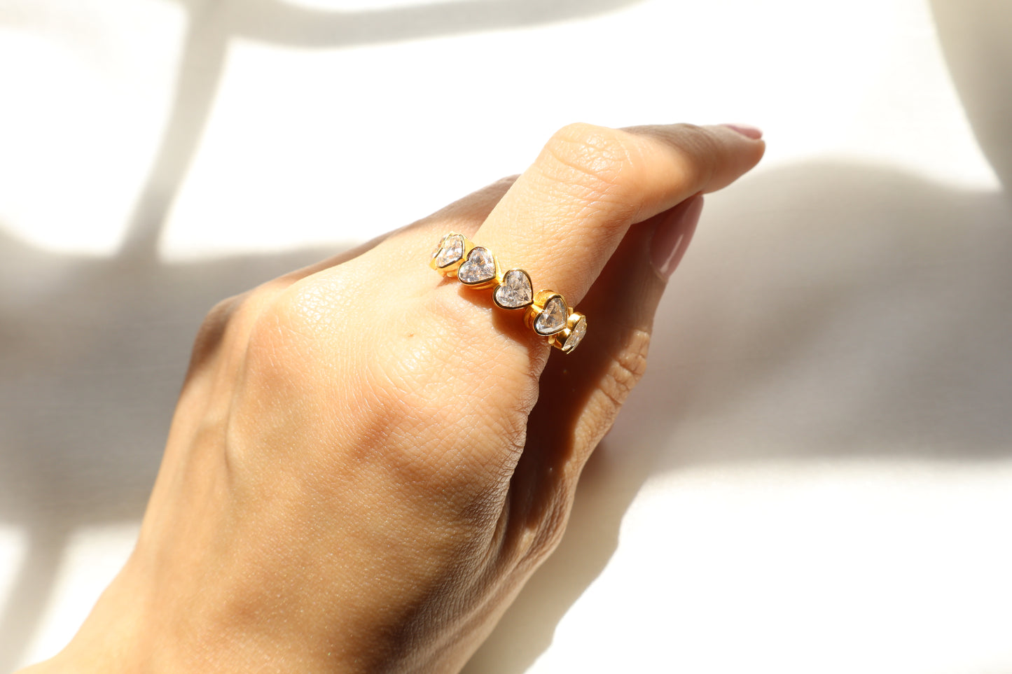 Custom 14K yellow gold ring with heart-cut diamonds, crafted using client-owned stones and secure precision setting, eco-friendly bespoke jewelry craftsmanship for Singapore clients.