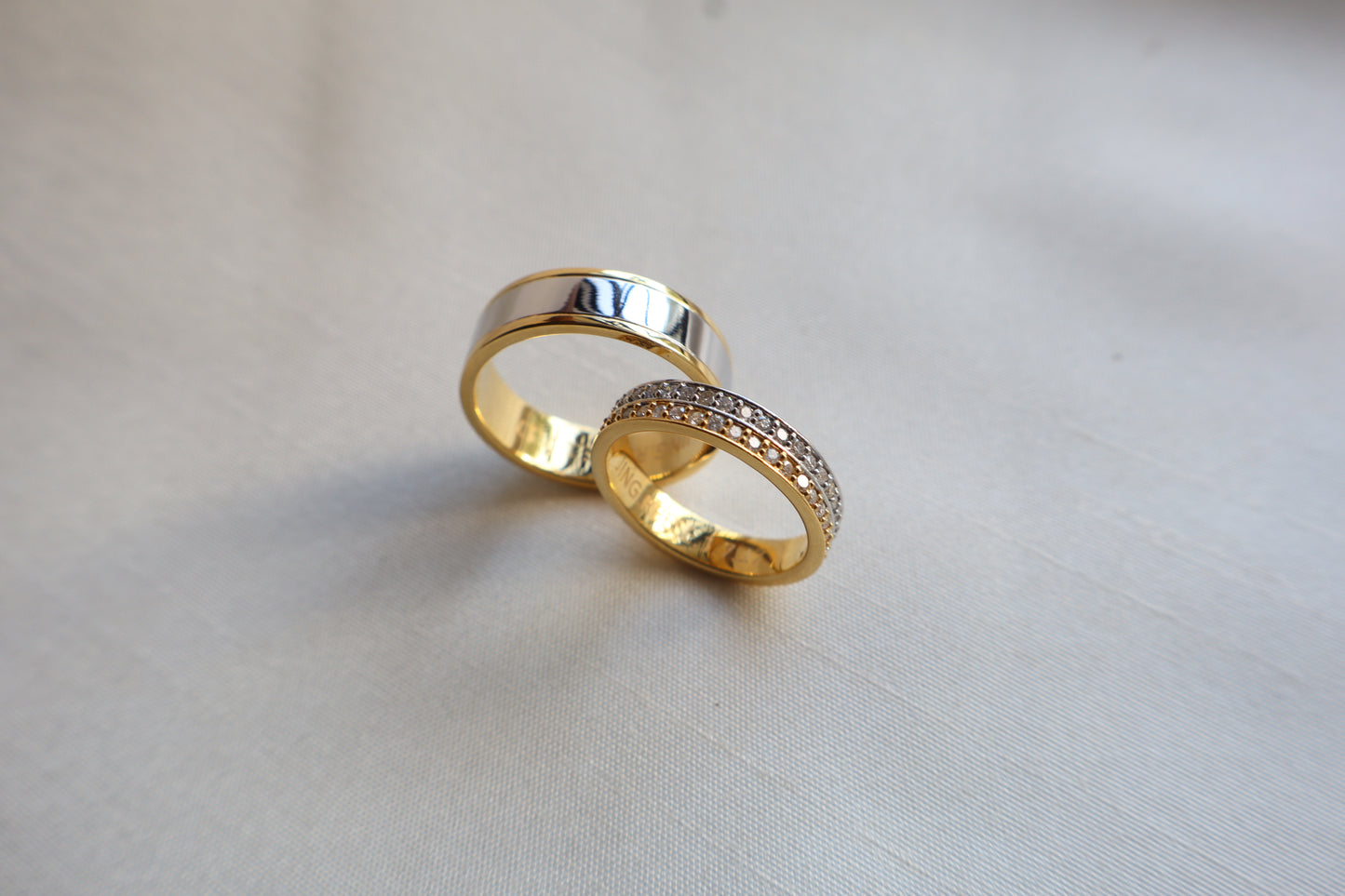 Elegant 14K two-tone wedding bands with high-polish and pavé details. Comes in eco-friendly Emildific packaging. Singapore corporate: premium gold craftsmanship.