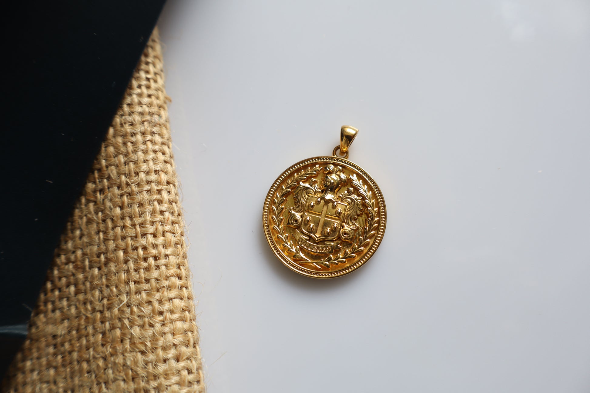Custom family crest pendant crafted in silver plated in gold, featuring a personalized coat of arms within a 23mm round medallion. Handcrafted as a bespoke heirloom inspired by European heraldry.