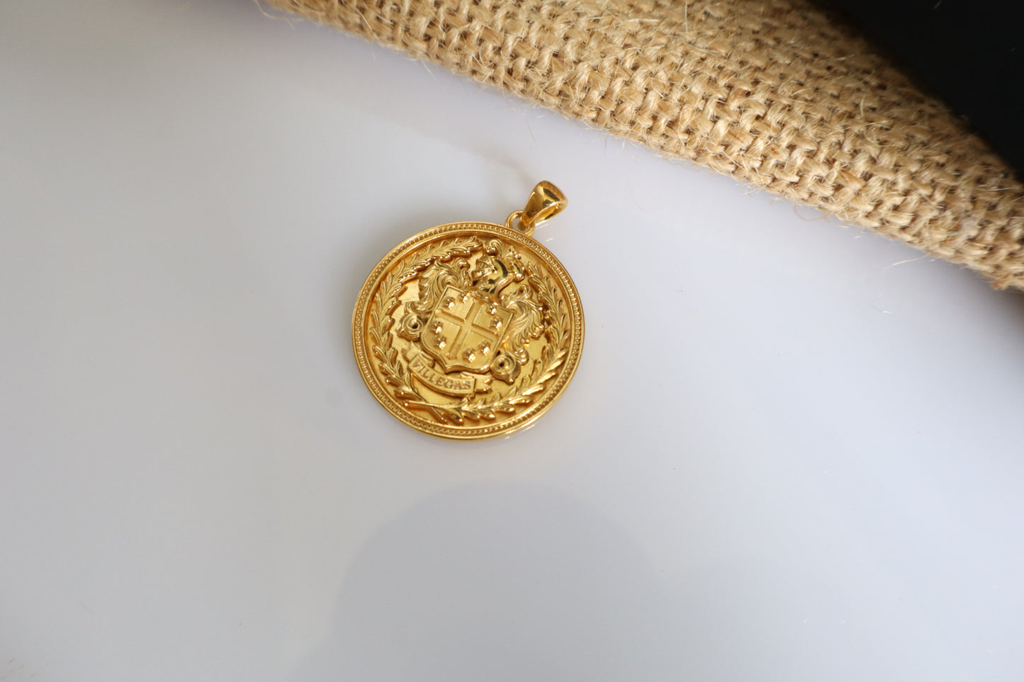 Custom family crest pendant crafted in silver plated in gold, featuring a personalized coat of arms within a 23mm round medallion. Handcrafted as a bespoke heirloom inspired by European heraldry.