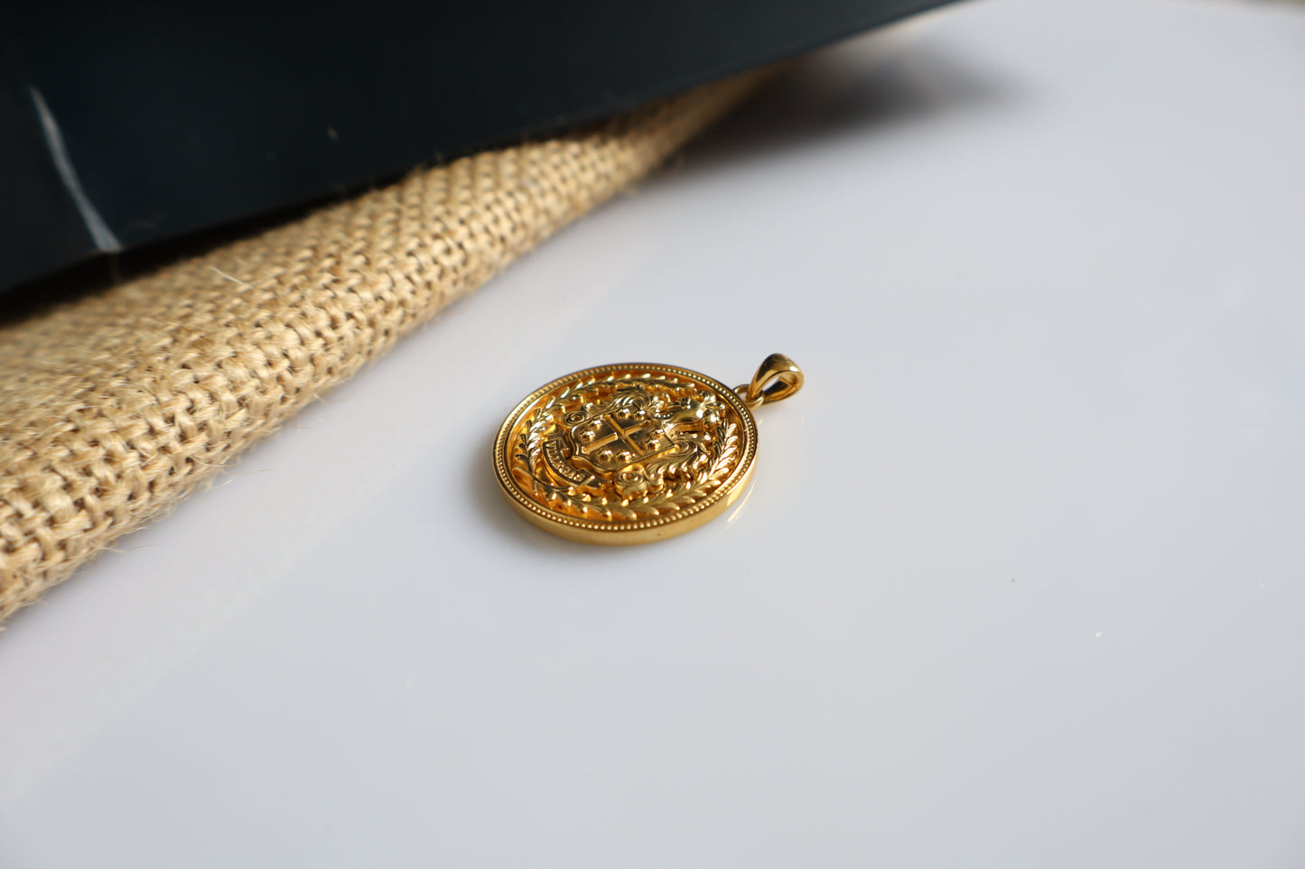 Custom family crest pendant crafted in silver plated in gold, featuring a personalized coat of arms within a 23mm round medallion. Handcrafted as a bespoke heirloom inspired by European heraldry.