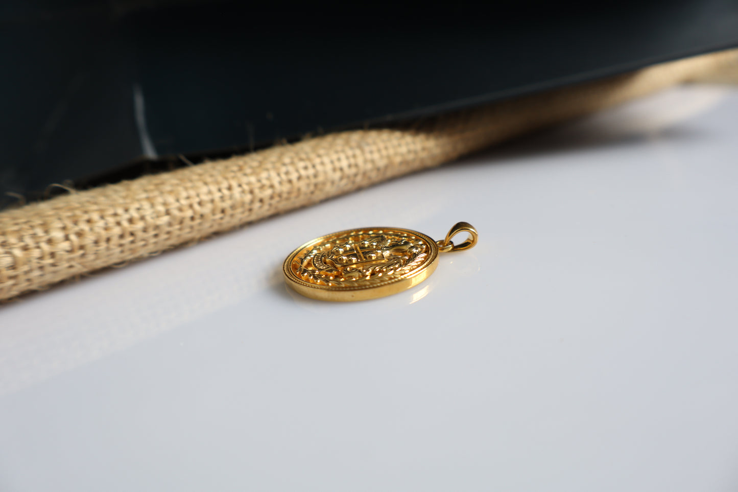 Custom family crest pendant crafted in silver plated in gold, featuring a personalized coat of arms within a 23mm round medallion. Handcrafted as a bespoke heirloom inspired by European heraldry.