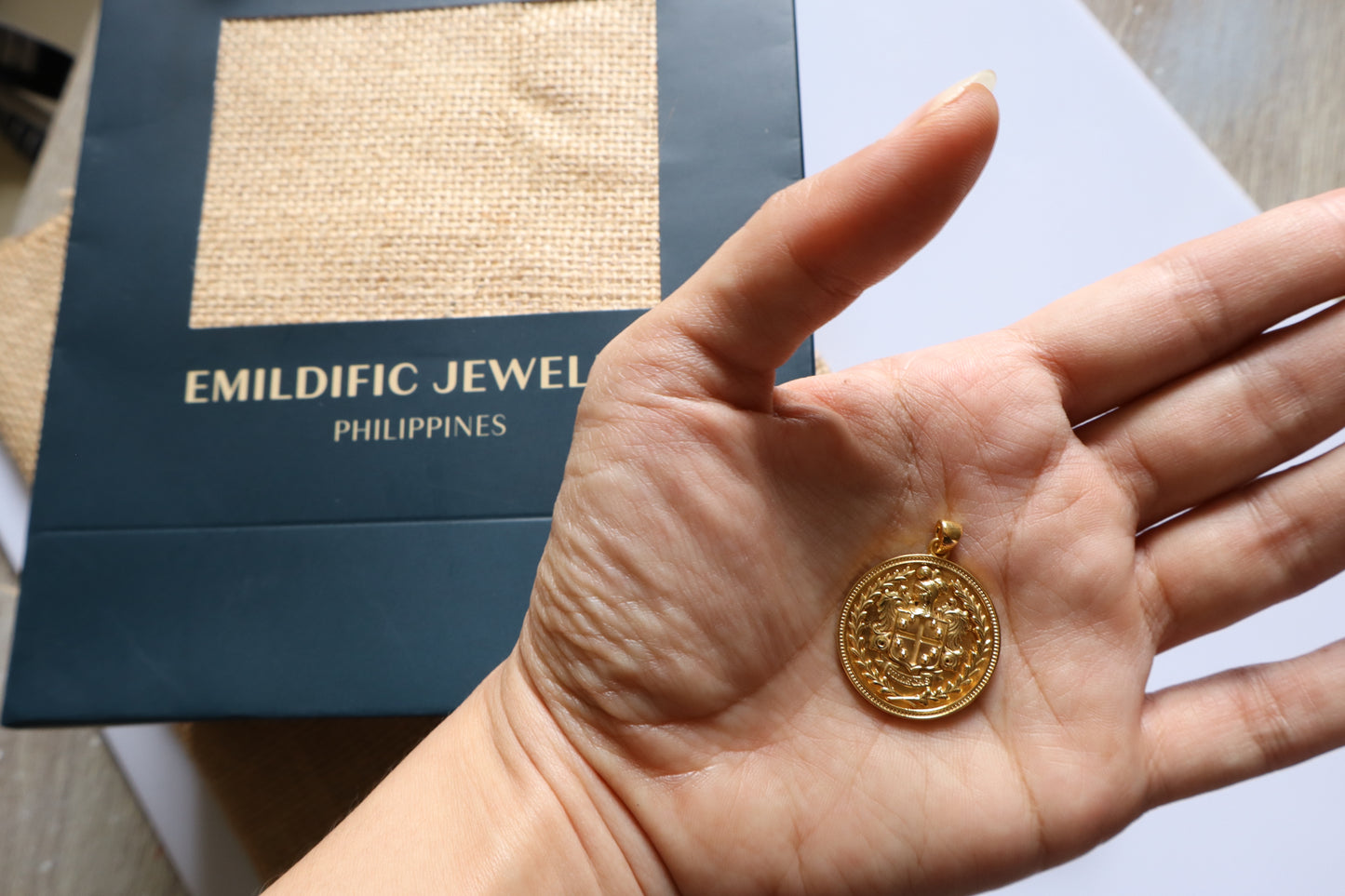 Custom family crest pendant crafted in silver plated in gold, featuring a personalized coat of arms within a 23mm round medallion. Handcrafted as a bespoke heirloom inspired by European heraldry.