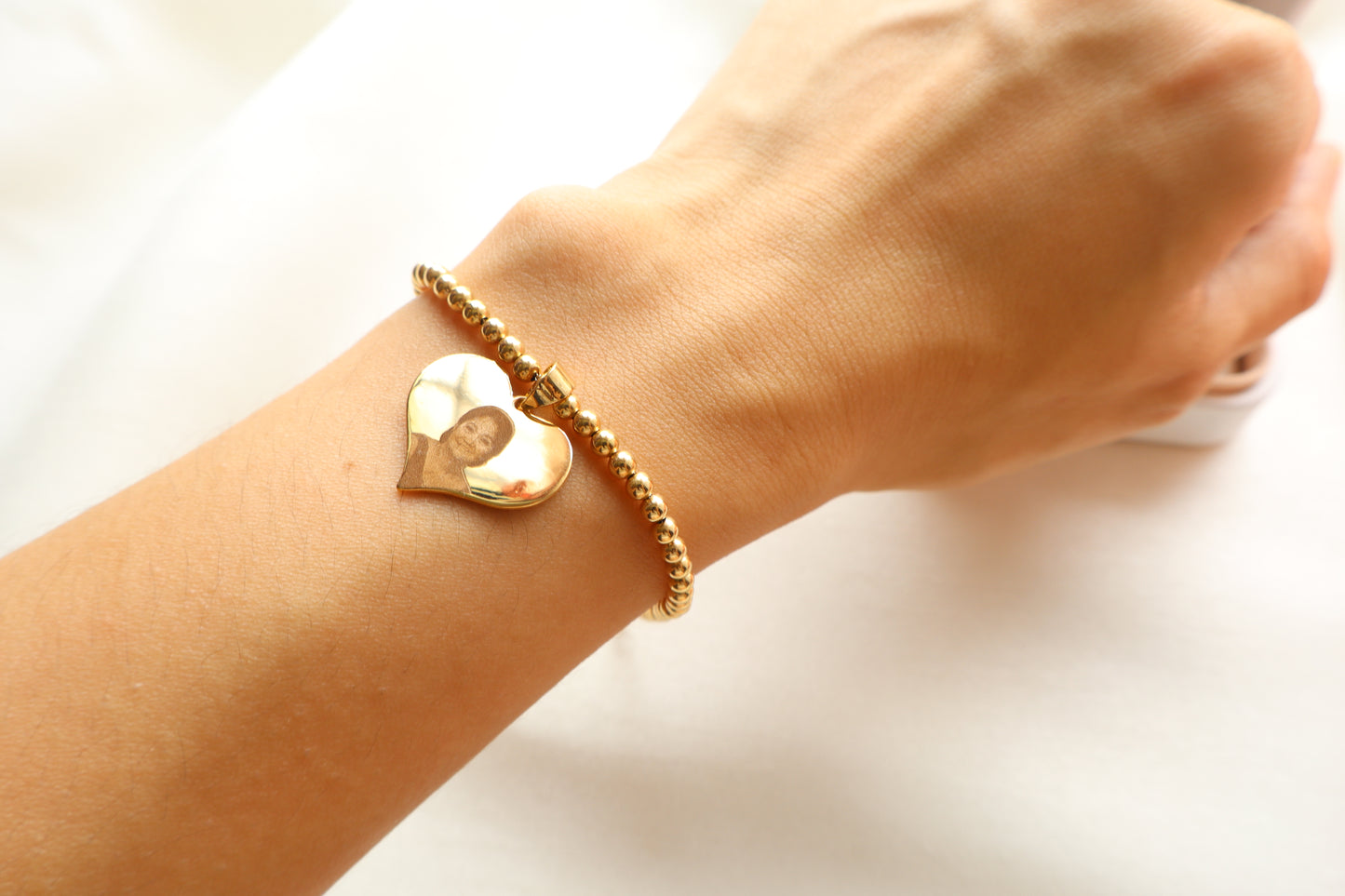 Personalized 14K Gold portrait-engraved heart charm on 7-inch 18K beaded chain. Ideal premium corporate giveaway and commemorative gift in Singapore