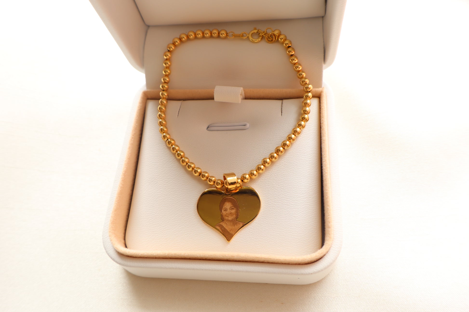 Personalized 14K Gold portrait-engraved heart charm on 7-inch 18K beaded chain. Ideal premium corporate giveaway and commemorative gift in Singapore