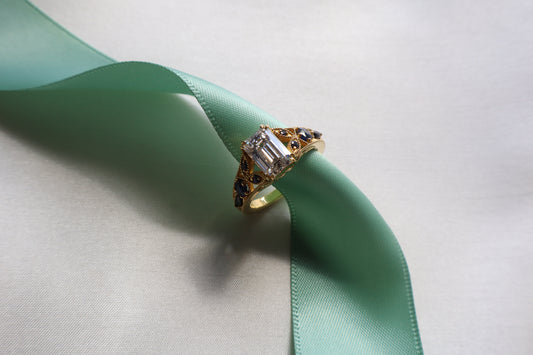 Custom 18K rose gold vintage-inspired engagement ring with intricate band detailing and elevated center stone, Singapore business milestone jewelry with eco packaging.