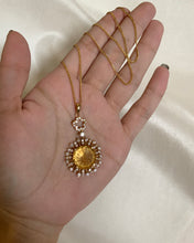 Load image into Gallery viewer, A round yellow citrine stone in bezzle moissanites and set in yellow gold. 

