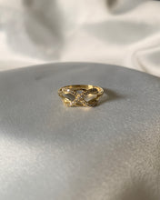 Load image into Gallery viewer, A gold infinity ring with small round shiny diamonds on the infinity symbol itself. Wrapped around a knot.
