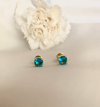 Load image into Gallery viewer, Blue topaz stud earrings in yellow gold setting. 
