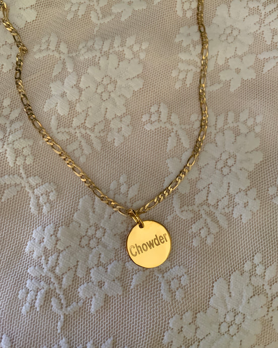 A round yellow gold pendant engraved with the pet's name. With a yellow gold Figaro chain to complete this gorgeous pet tag.