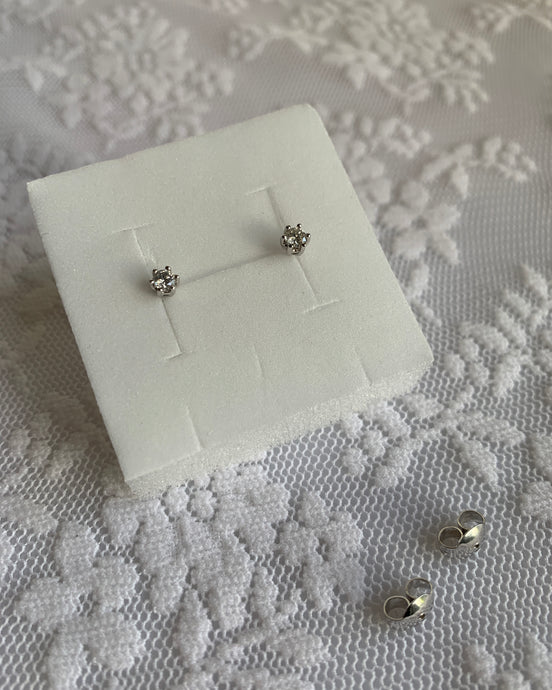 Small diamond stud earrings in white gold setting.