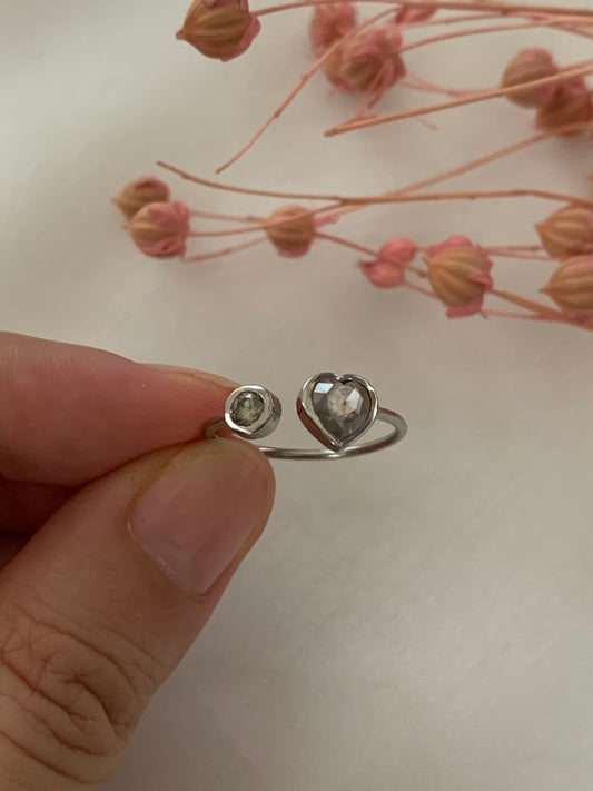 Made of round and heart shaped rose cut diamonds.wrapped around your finger with a space at the middle of the ring-- for adjustable ring sizes.