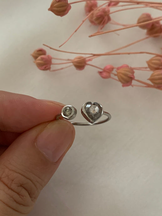 Made of round and heart shaped rose cut diamonds.wrapped around your finger with a space at the middle of the ring-- for adjustable ring sizes.