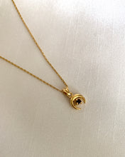 Load image into Gallery viewer, A gold crescent downside moon with a round garnet stone. All set in yellow gold.
