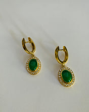 Load image into Gallery viewer, A pair of oval jade earrings set in a diamond bezzle. All in a 14Karar gold setting too.
