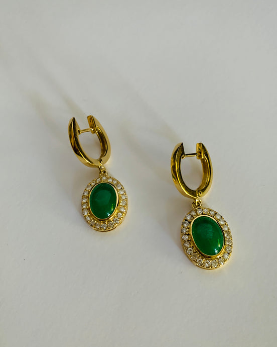 A pair of oval jade earrings set in a diamond bezzle. All in a 14Karar gold setting too.