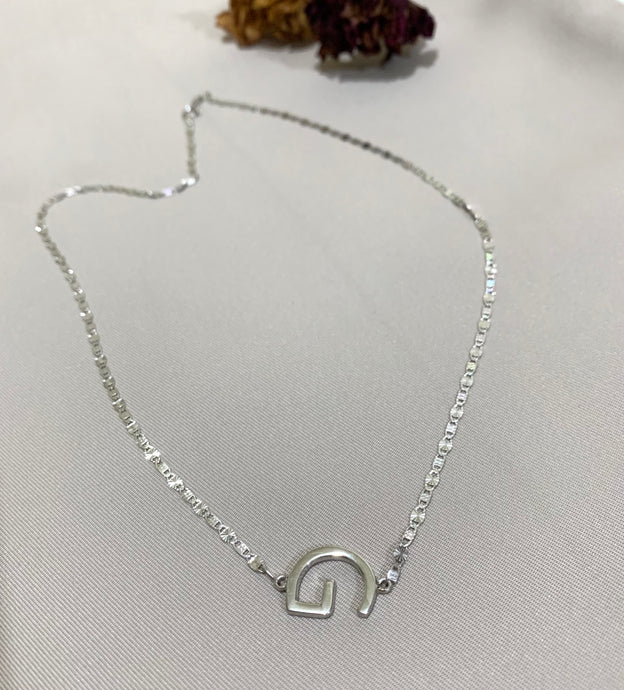 White gold G initial sideways necklace.