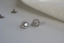 Load image into Gallery viewer, 2 round sparkling diamond earrings with halo in white gold setting. 
