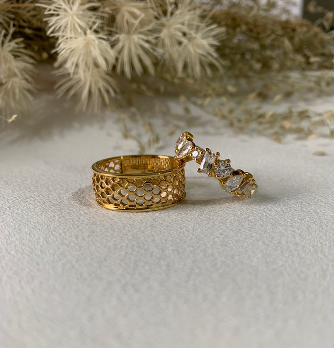 Yellow gold honeycomb ring and 9 different shapes of diamonds set in yellow gold.