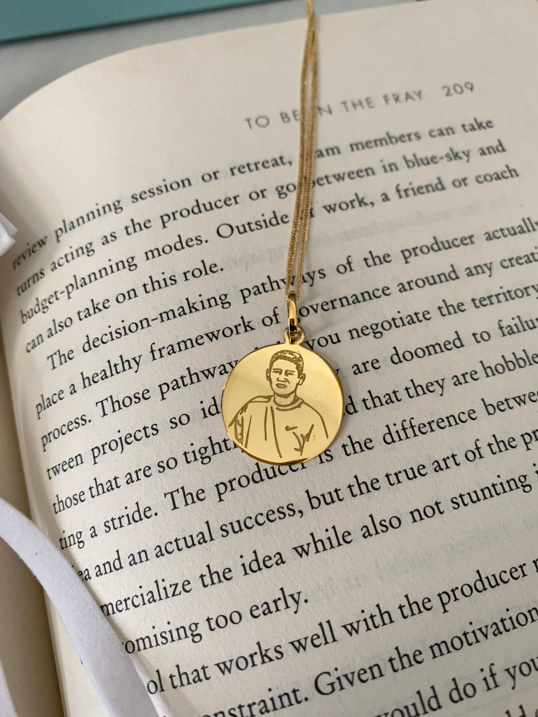 Gold round pendant with a personalized photo in an 18karat gold chain. 