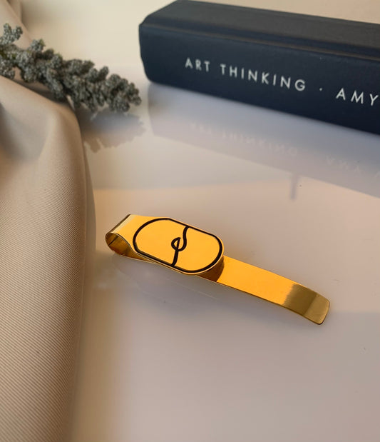 Customized gold logo money clip that can also be a bookmark. 