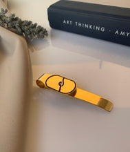 Load image into Gallery viewer, Customized gold logo money clip that can also be a bookmark. 
