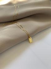 Load image into Gallery viewer, A yellow gold mini bar necklace. 
