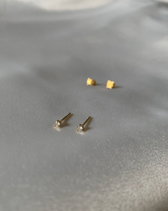 A .05 diamond carat each ear on a tri-prong and set in yellow gold.