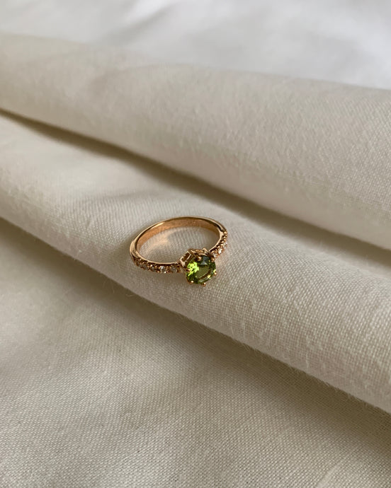 Round Peridot Ring with Accents of Round Diamonds Set in 18 Karat Yellow Gold
