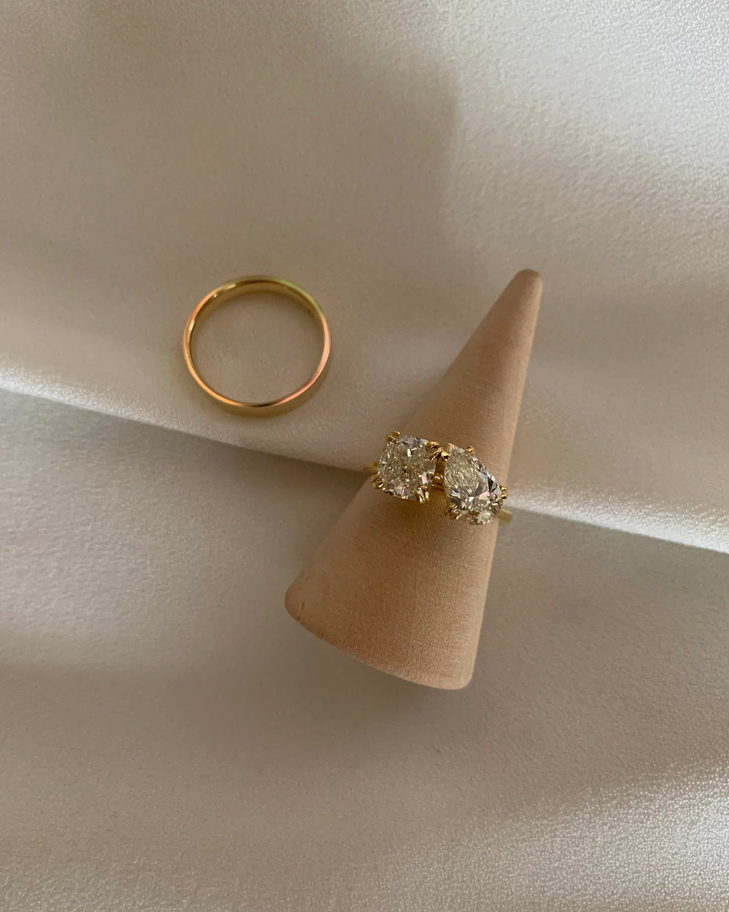 An 18k Gold engagement ring. Set with 1.02carat of round and pear-shaped diamonds met in the middle of the elegant and timeless design of gold band. 