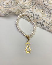 Load image into Gallery viewer, 22 pieces of freshwater white pearls with a gold boy charm. Also with a ball clasp as its lock. 

