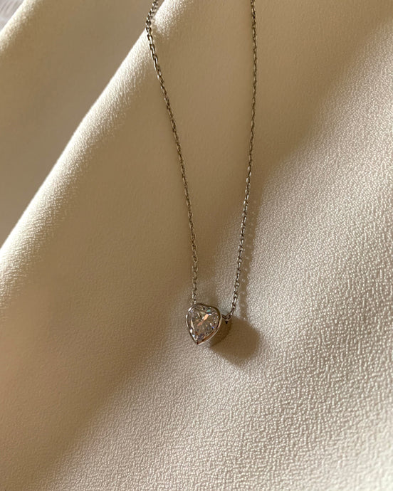 A Floating Heart Diamond Necklace With An Open Back Design Set In 18K White Gold
