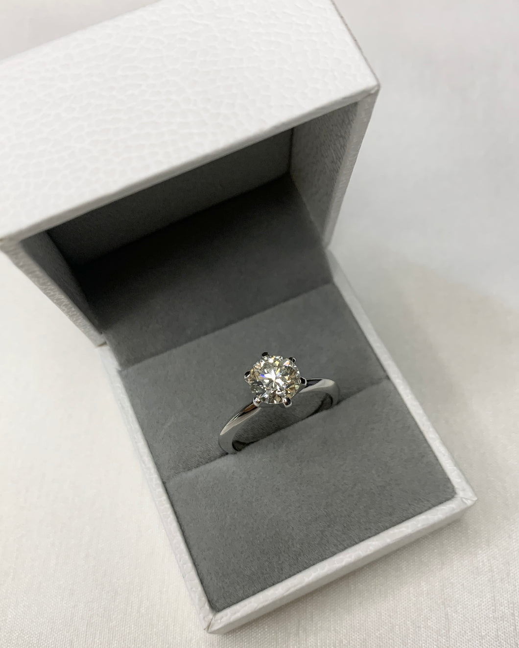 1.51 carat lab grown diamond set in six prongs, in 14k white gold.