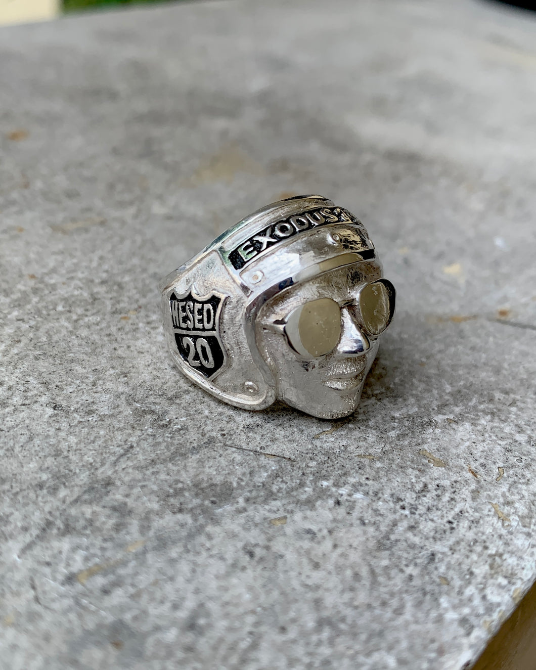 A silver motorcycle rider inspired ring with engravements. 