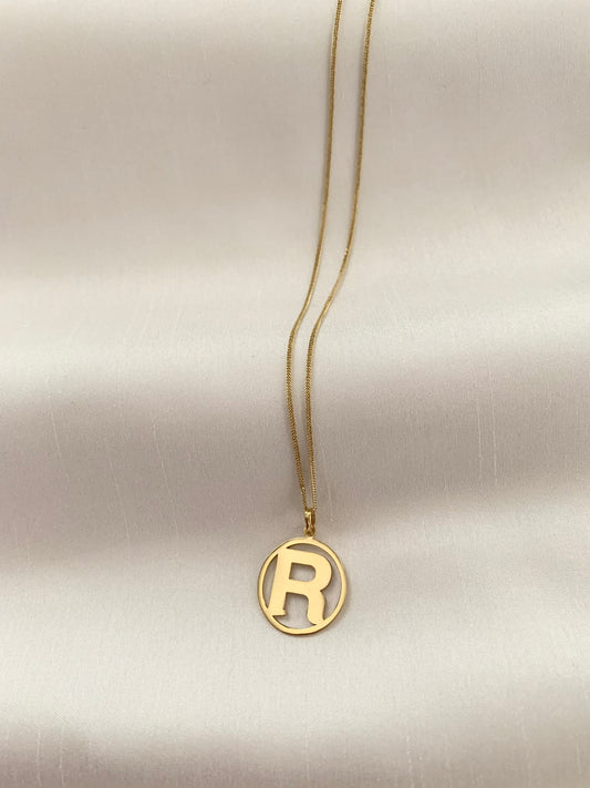 Gold R initial pendant enclosed on an 18k gold too. 