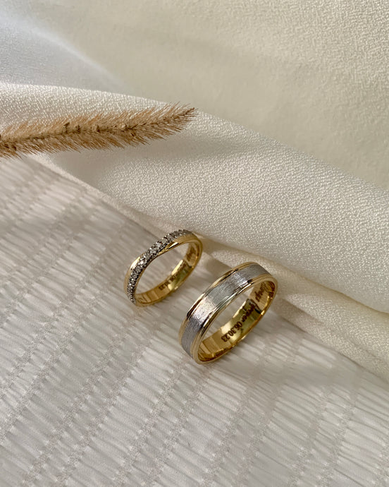 His: 14k White Gold at the middle, Brushed Beveled Edge Wedding Ring and 14k yellow gold polished edge. Hers: Simple infinity ring design with small round diamonds as an accent. Set in 14k yellow gold.