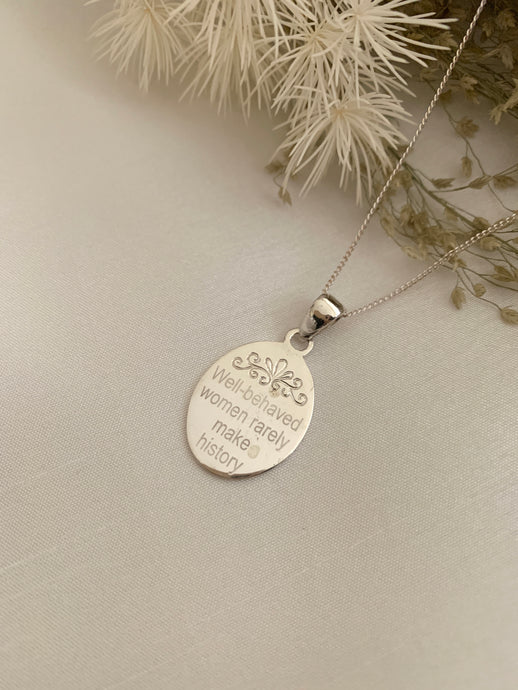 An oval necklace with a saying 