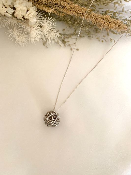 Pendant is a white gold ball of yarn in a white gold chain necklace.